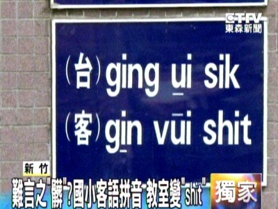 sign on a classroom wall reading '(?) ging ui sik / (?) gin vui shit'