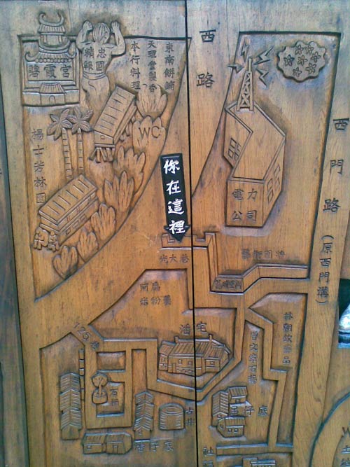 bas relief wood carving of area roads, with some buildings indicated